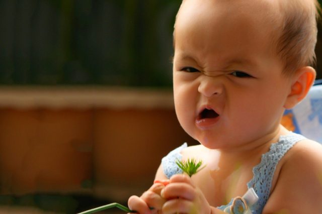 A funny expression on baby girl face.