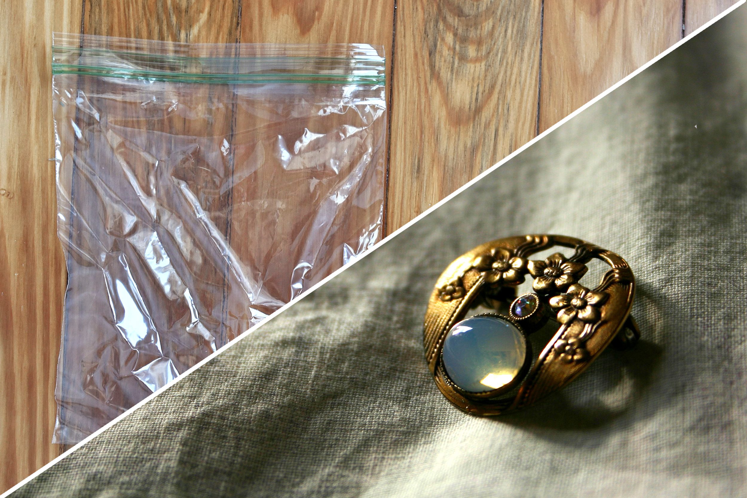A clear plastic bag rests on wooden boards; a decorative brooch with floral designs lies on textured fabric.