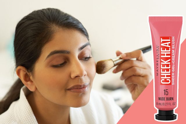 Makeup brush applies blush to cheek; woman wears white robe. Text on blush packaging: 