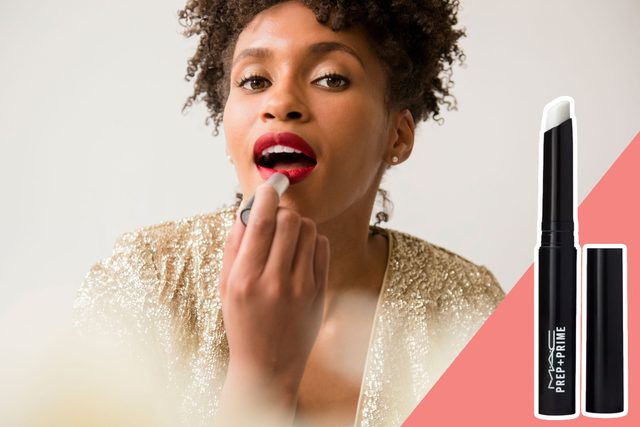 A person applies red lipstick, wearing a sparkling gold top; beside is a MAC Prep + Prime product on a pink background.