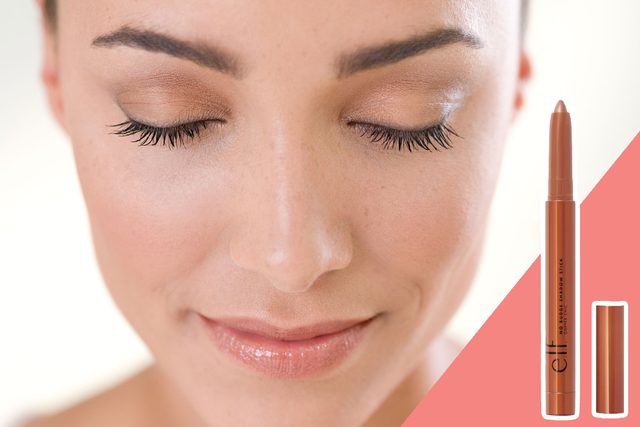 Woman closes eyes, showcasing natural makeup; beside her, an e.l.f. eye shadow stick is displayed on a pink background.