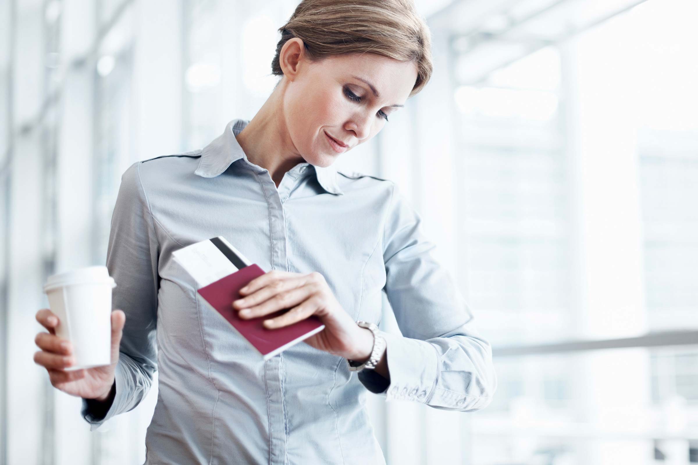 Airplane travel tip woman with coffee and boarding pass