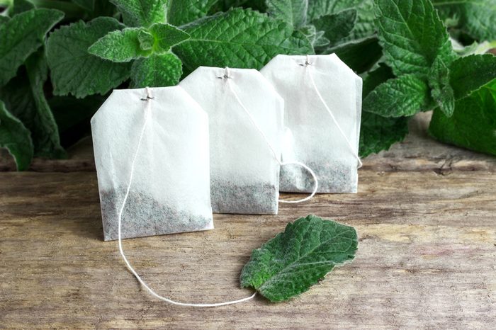 White tea bags with mint leaves