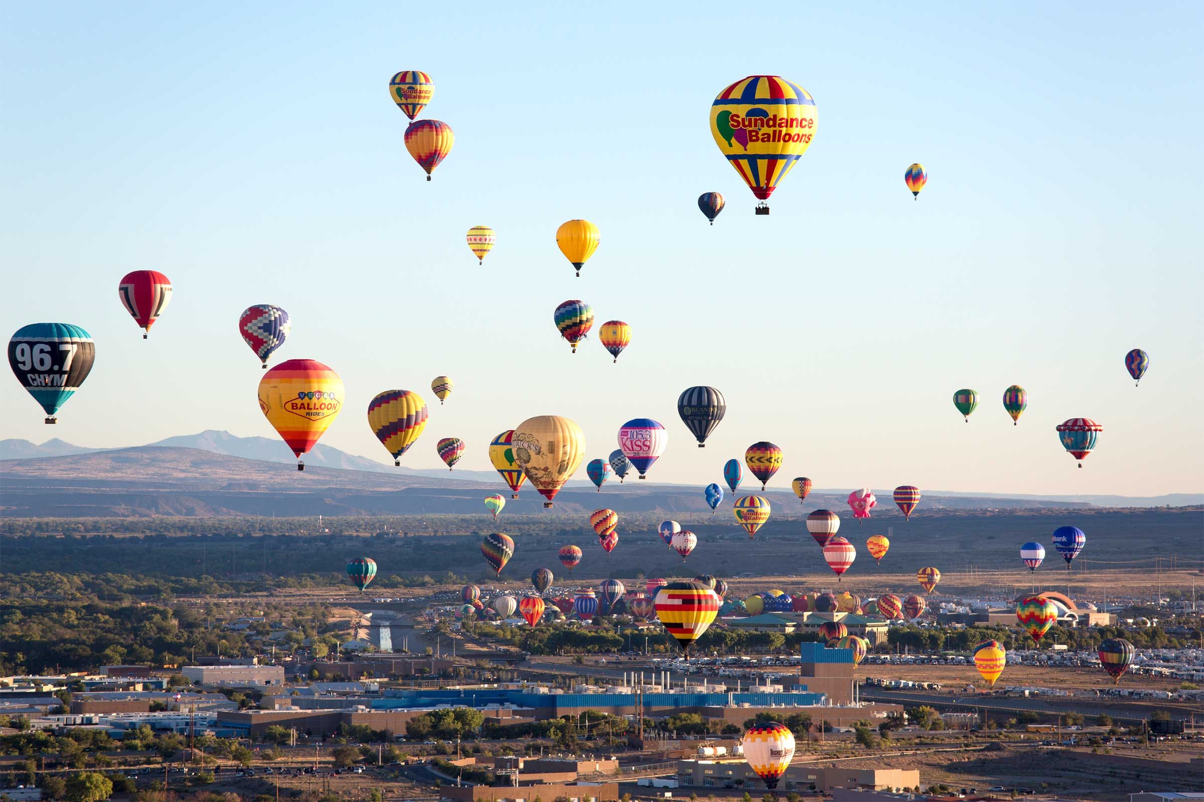 a large gathering of hot air balloons above Albuquerque in New Mexico