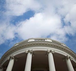 White House below a blue sky with clouds