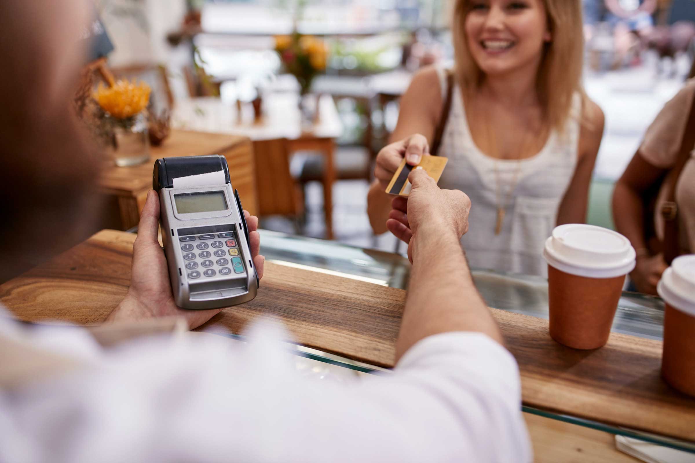 woman handing her credit card to cashier