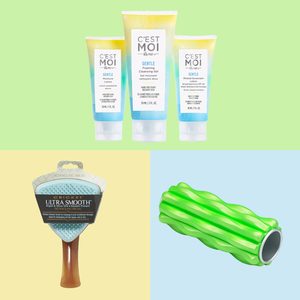 Skincare tubes stand together on a green background; a blue detangling brush and green foam roller rest below on yellow and blue backgrounds, respectively.