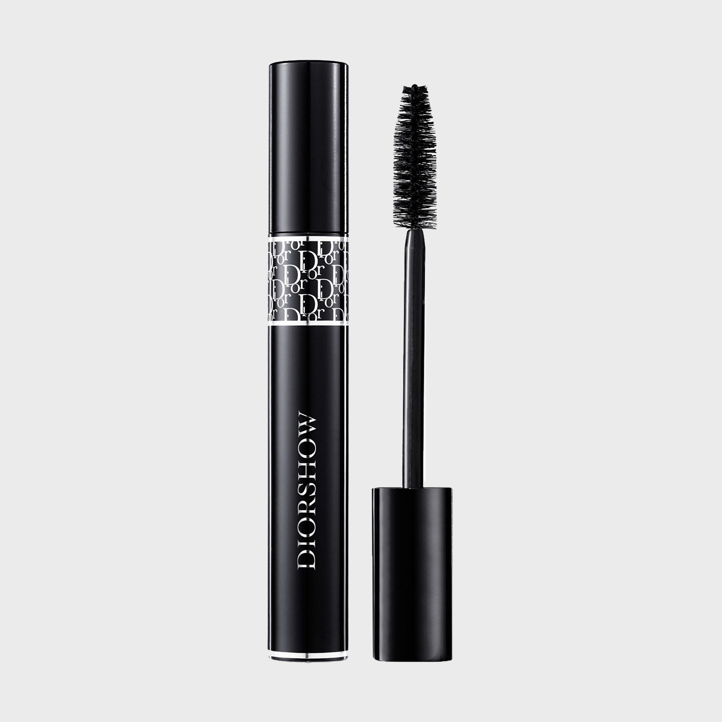 Mascara tube open, brush alongside, brand name "DIORSHOW" visible, elegant design with logo pattern, isolated on a plain background.