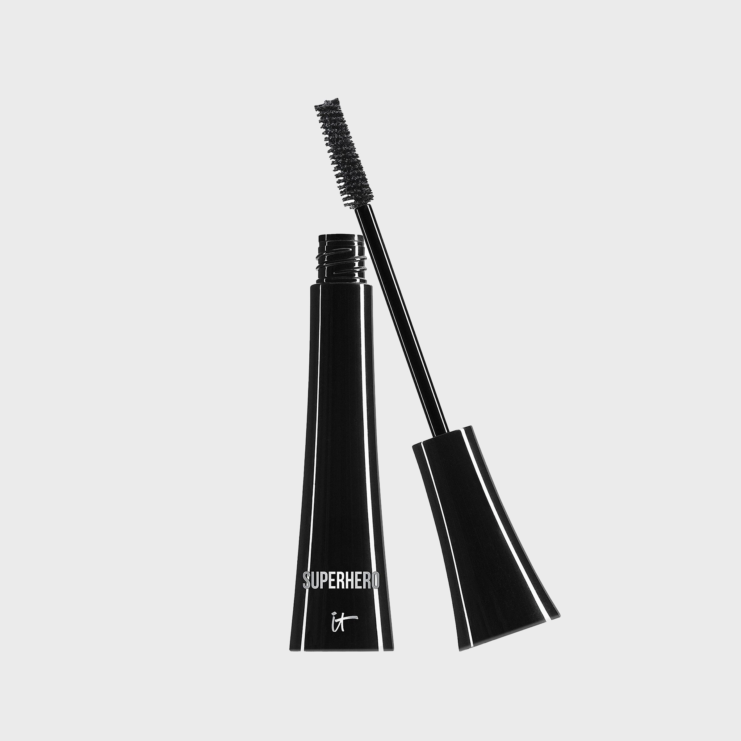 Black mascara wand stands upright, open, against a plain background with text "SUPERHERO it" on the container.