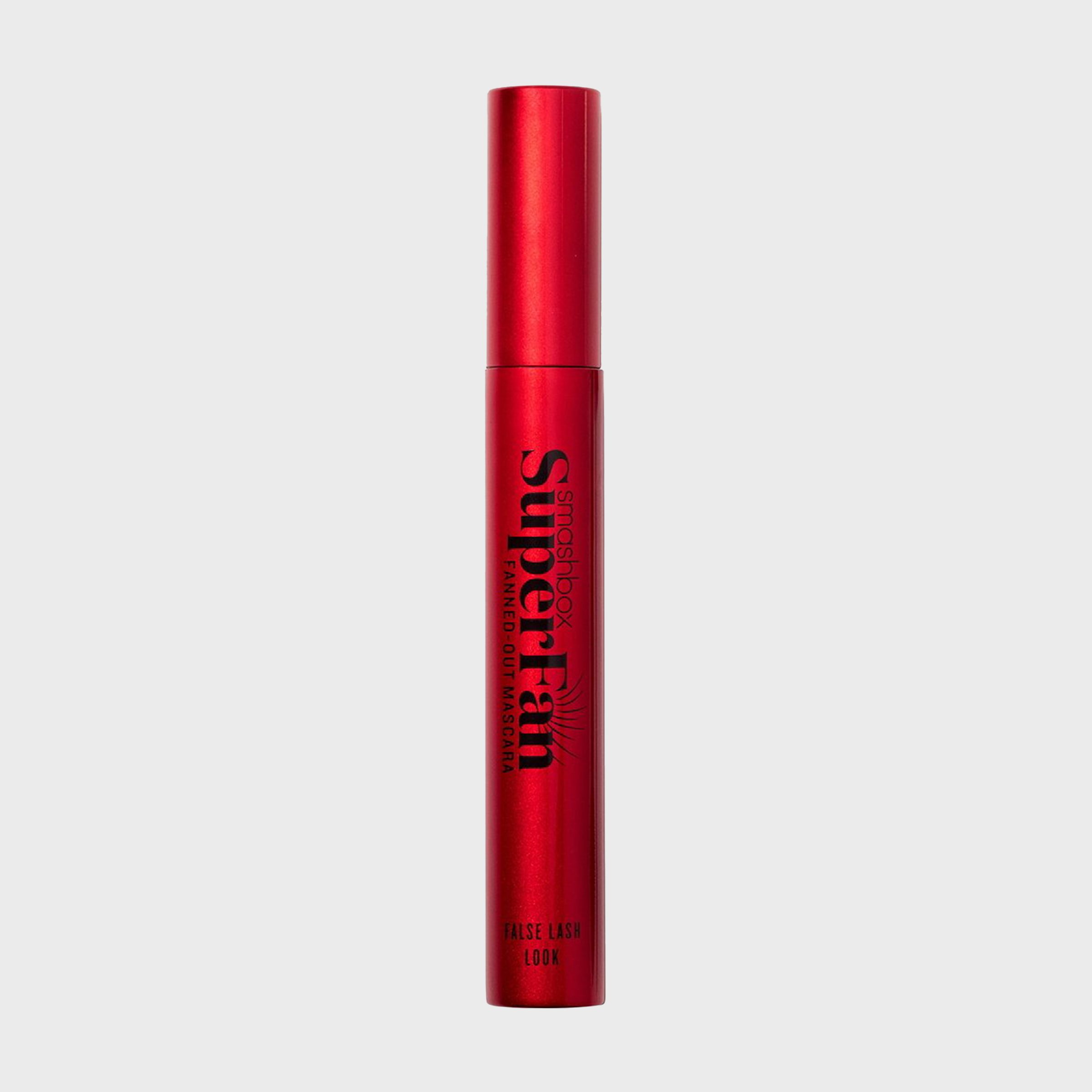 A red mascara tube stands upright on a white background, labeled "Smashbox Super Fan Fanned-Out Mascara, False Lash Look."