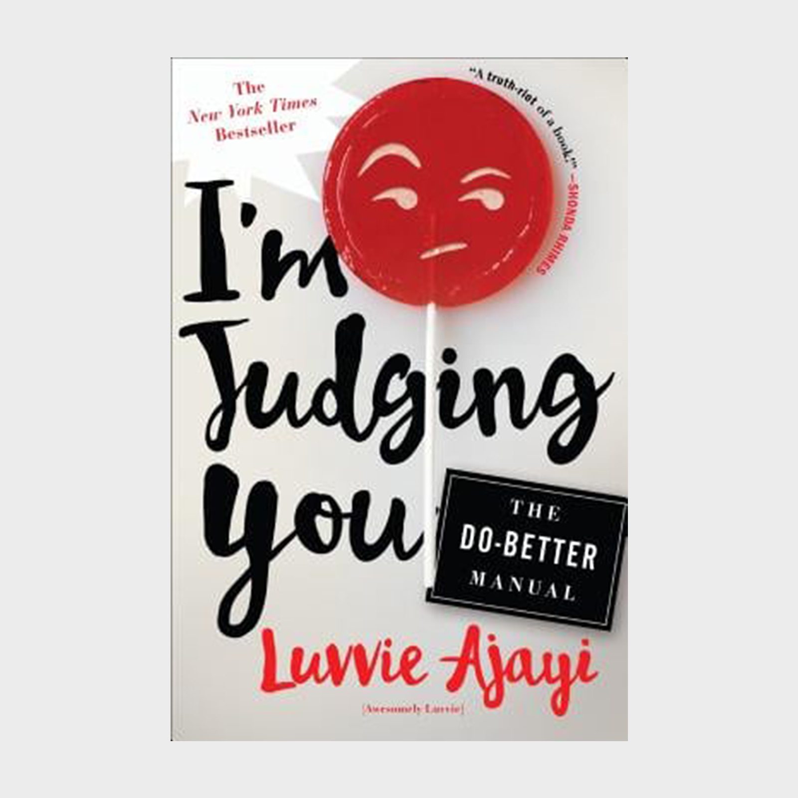 Book cover features bold text "I'm Judging You," a red face lollipop, and "The Do-Better Manual" set against a white background.