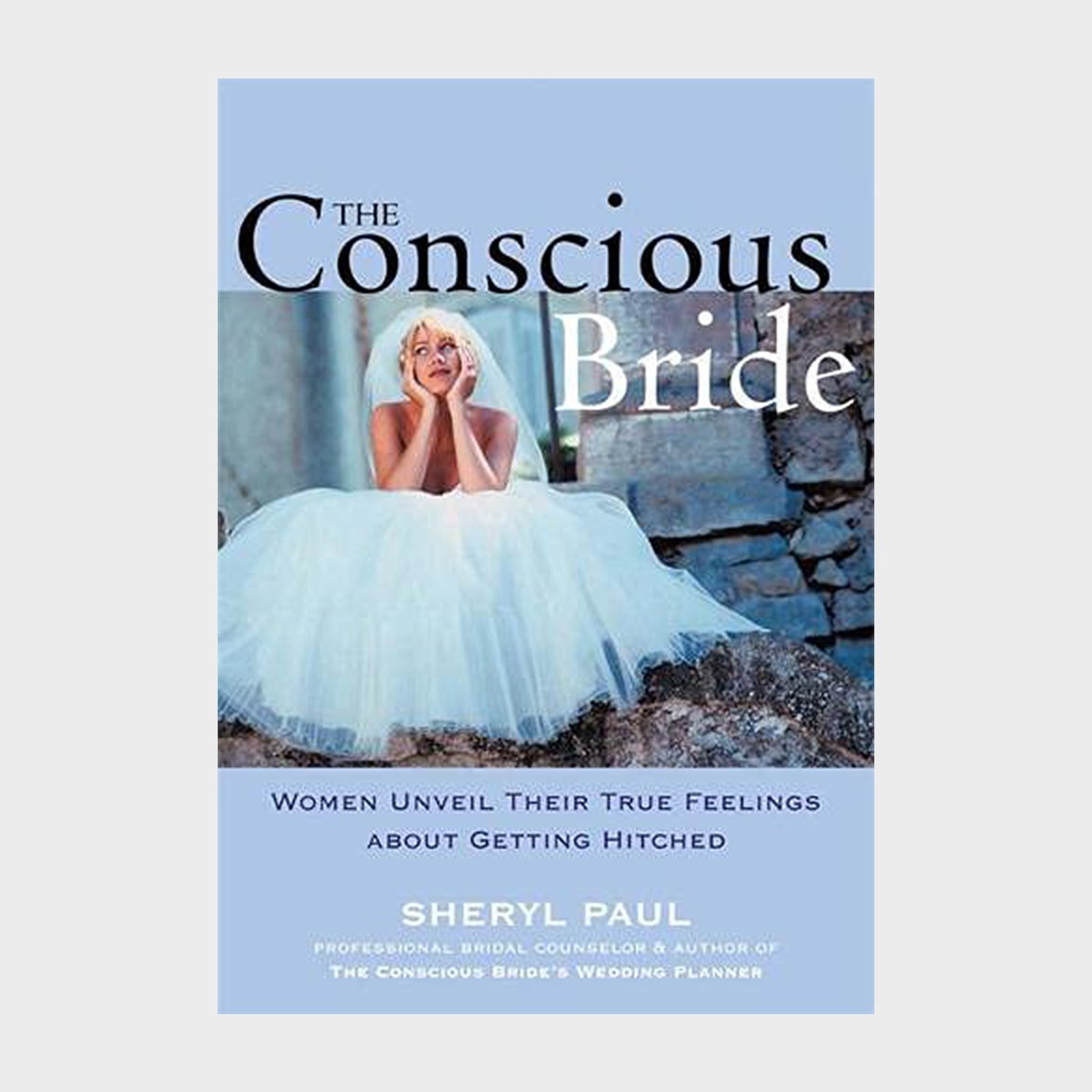 A bride sits thoughtfully on stone steps, wearing a full white dress, against a rustic background. Text: "The Conscious Bride" by Sheryl Paul.