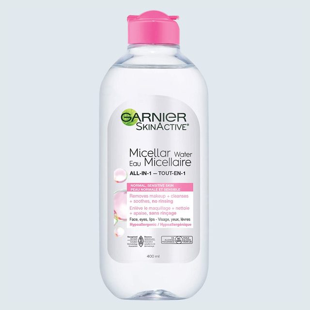 A clear plastic bottle with pink cap labeled 