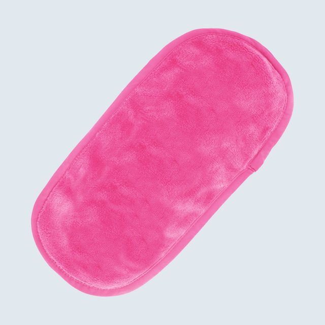 Pink padded oval object lies flat against light gray background.