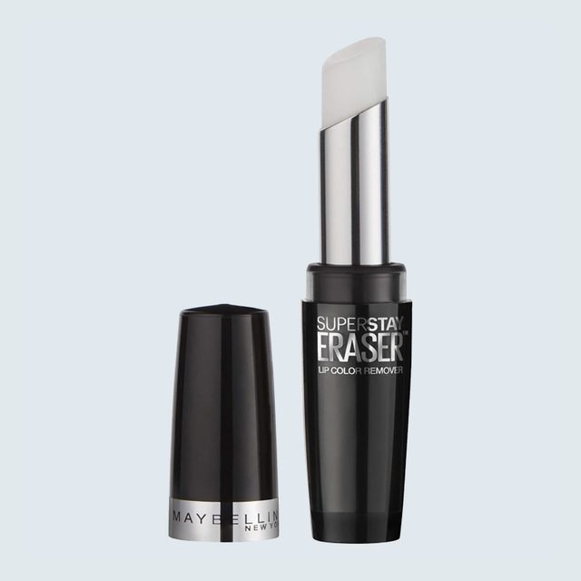 Lip color remover stick standing upright, exposed tip showing. Cap lies beside it. Text reads 