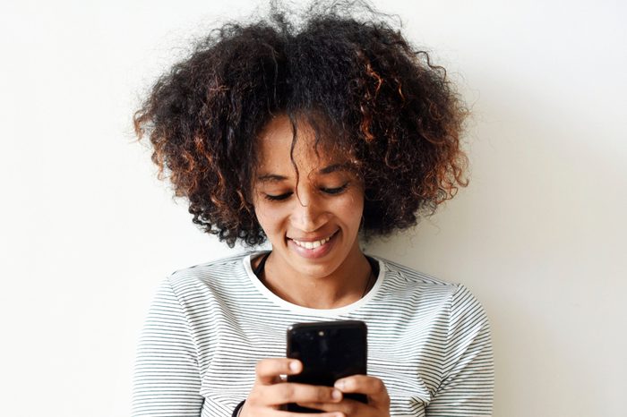 Smiling woman using a smartphone