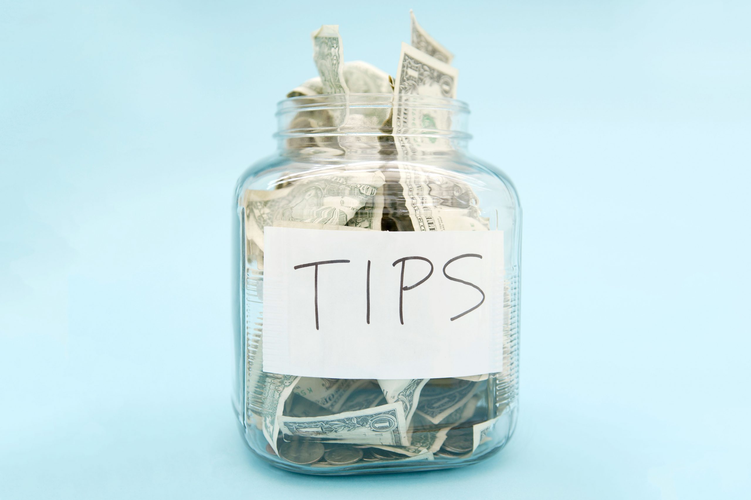 tip jar with USD on a light blue background