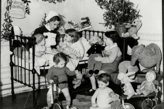 Mandatory Credit: Photo by  (2010874a)A Nurse With Children Surrounded By Christmas Presents At The Children's Hospital Hampstead - Christmas 1936.A Nurse With Children Surrounded By Christmas Presents At The Children's Hospital Hampstead - Christmas 1936.