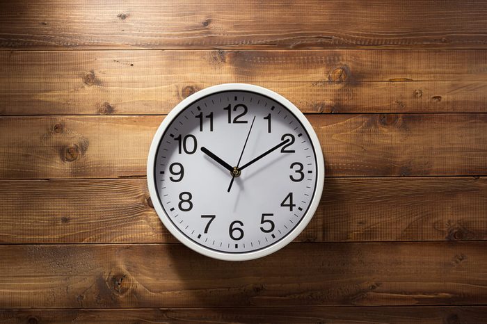 wall clock at wooden background texture