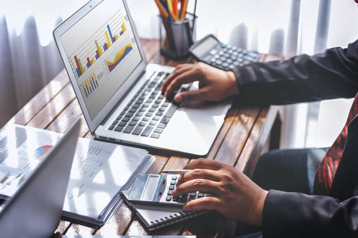 Businessmen working together at office desk, hands close up pointing out financial data. teamwork workplace strategy Concept.