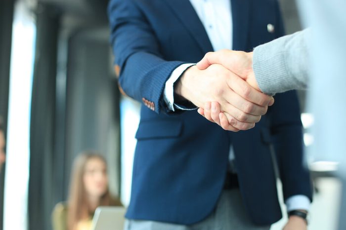 Business people shaking hands, finishing up a meeting.