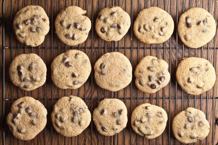 Cool top view shot of a dozen freshly baked homemade chocolate chip cookies on a cooling rack
