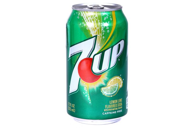 A green 7UP can features lemon-lime graphics, showing bubbles and citrus slices, labeled "Lemon Lime Flavored Soda" and "Caffeine Free," with 12 fl oz content.