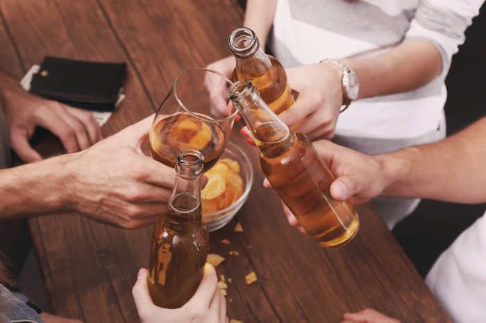 View on friends having alcoholic drinks in the bar, close-up