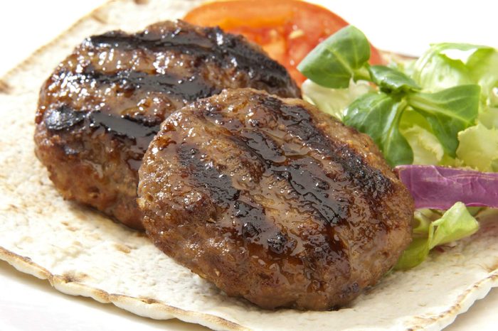 two burgers with salad on a pita