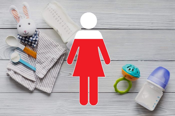 baby toys on wooden background with woman symbol overlay