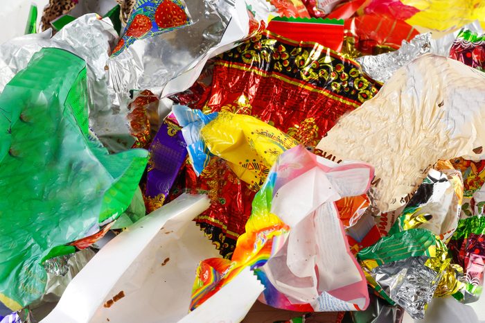 A bunch of candy wrappers on a white background. Closeup.