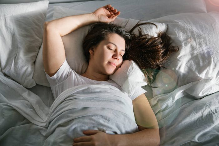 woman sleep in bed sunshine thought the window