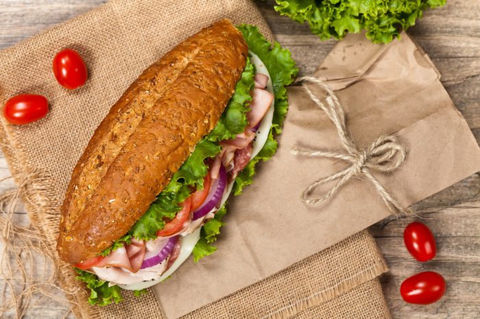 Italian Sub Sandwich with Salami, Tomato, and Lettuce. Selective focus.