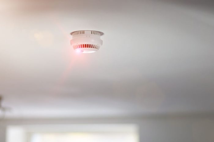 Smoke detector mounted on roof in apartment