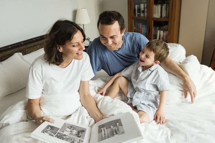 Family looking and sharing memories by the photo album