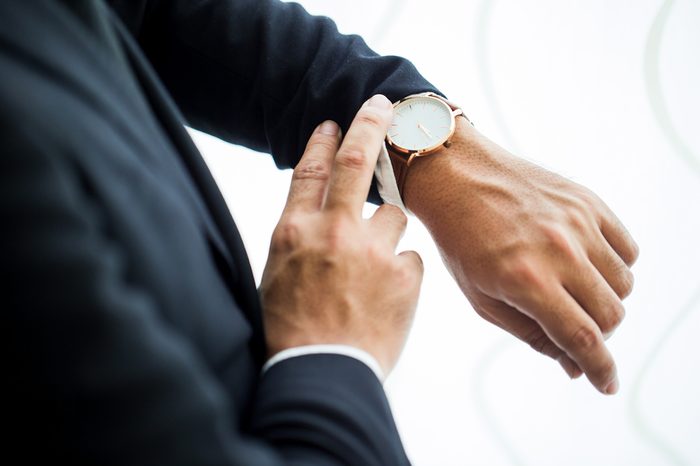 Businessman looking at his watch in office