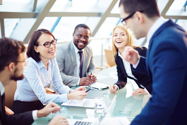 Business people laughing together at meeting