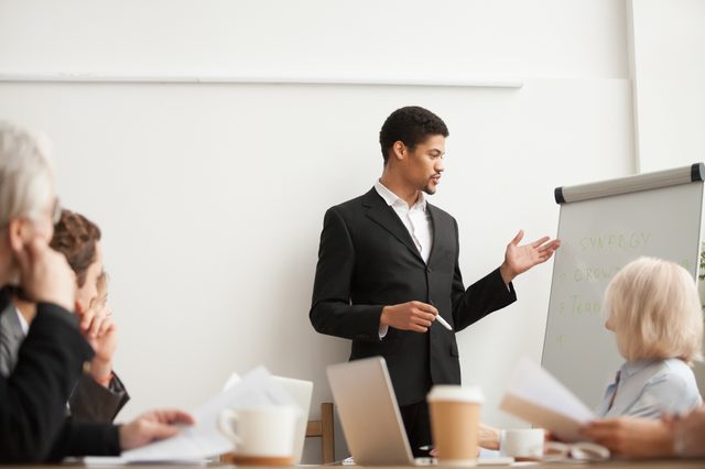 African american speaker presenting new strategy to partners, black coach giving presentation to employees at conference meeting, dark-skinned team leader reporting about work result with flip chart