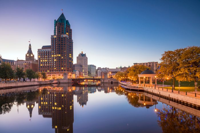 Downtown skyline with Buildings along the Milwaukee River at night, in Milwaukee, Wisconsin.