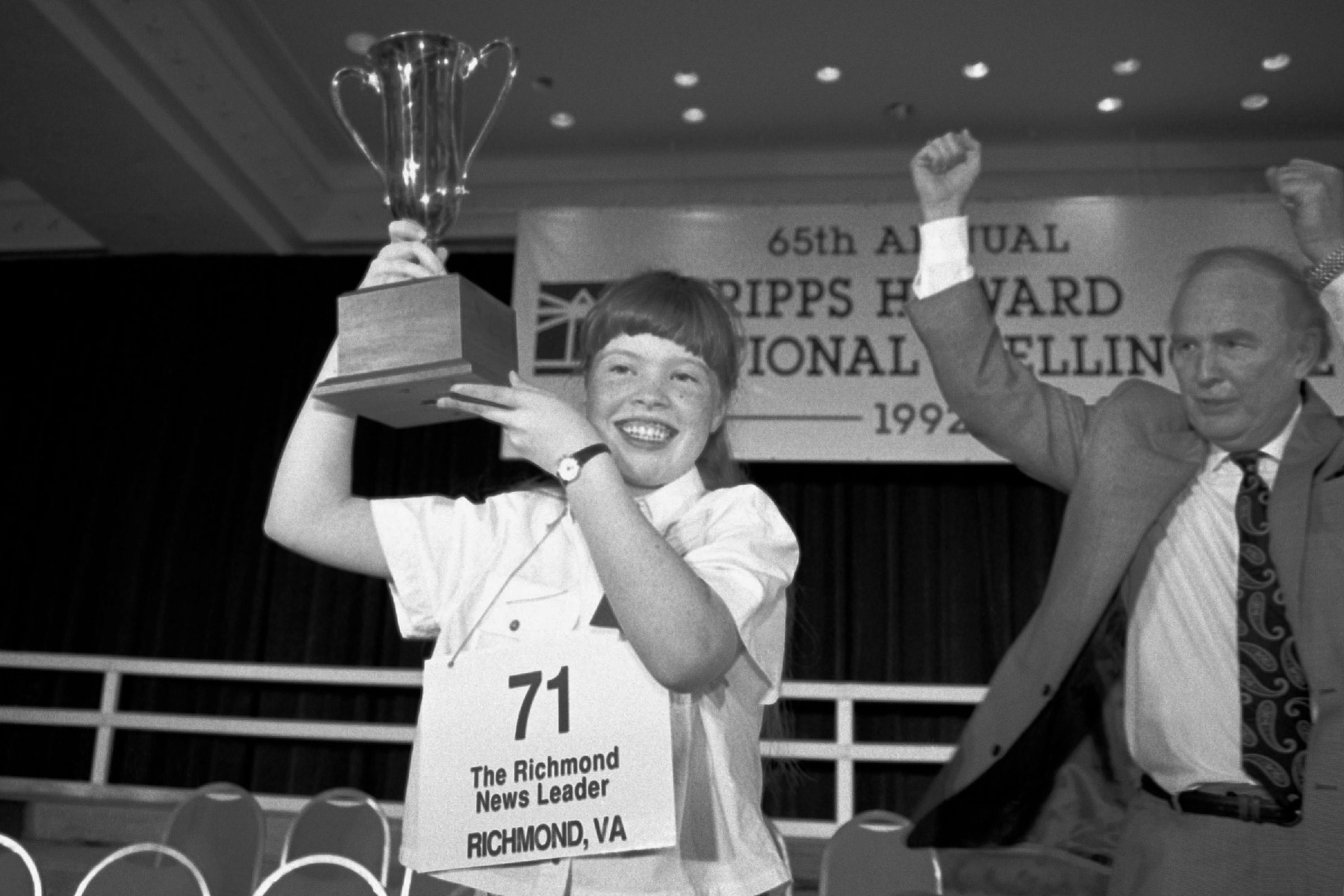 Amanda Goad, Dan Thomasson Amanda Goad, 13, of Richmond, Va., holds up her trophy after spelling "lyceum" correctly to win the 65th annual National Spelling Bee in Washington, D.C., . Dan Thomasson, vice president of Scripps-Howard celebrates at right