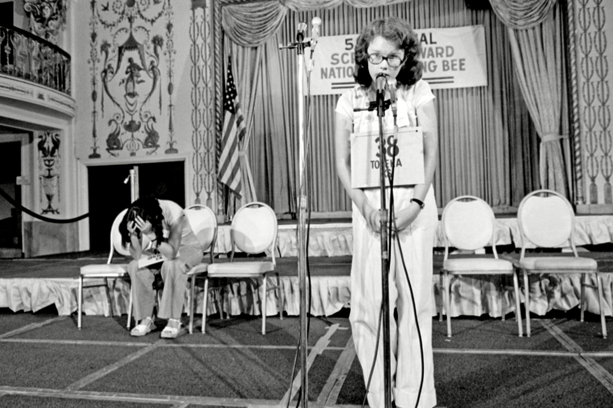 Peg McCarthy, Lyn Sue Kahng Peg McCarthy of Topeka, Kansas, spells the world "deification" to win the 51st National Spelling Bee in Washington, D.C., . The runner-up Lyn Sue Kahng, seated left, puts her head in her hands. Kahng is from San Diego