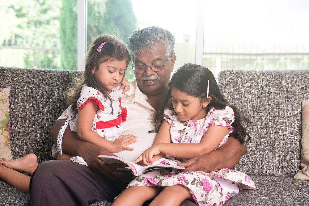 indian grandfather learning with his granddaughters
