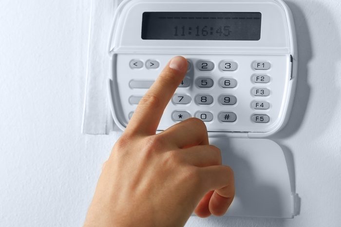 Male hand pressing the code on a house alarm