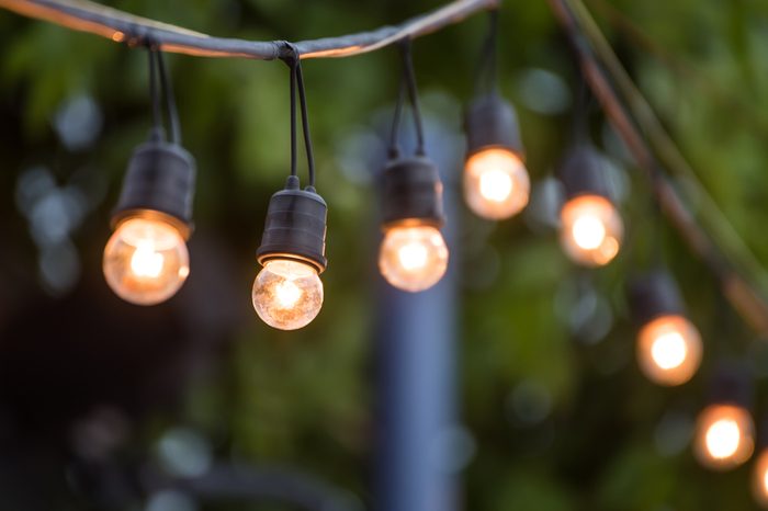 Hanging decorative christmas lights for a wedding ceremony