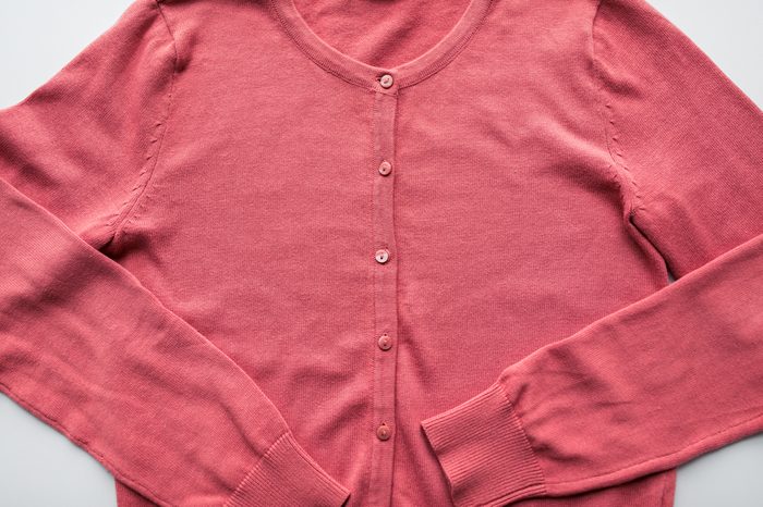 clothing, wear, fashion and objects concept - close up of cardigan