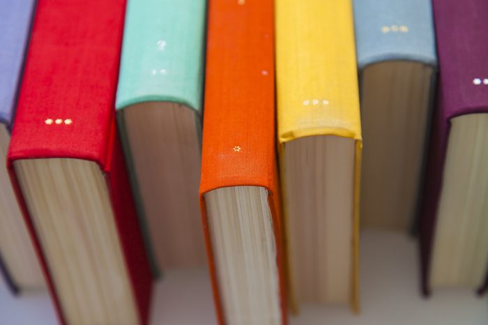 Stack of vintage books in multicolored covers