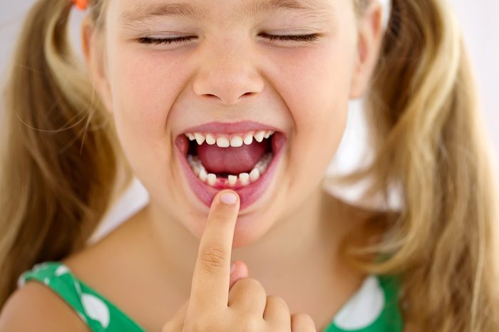 The child dropped the first milk tooth