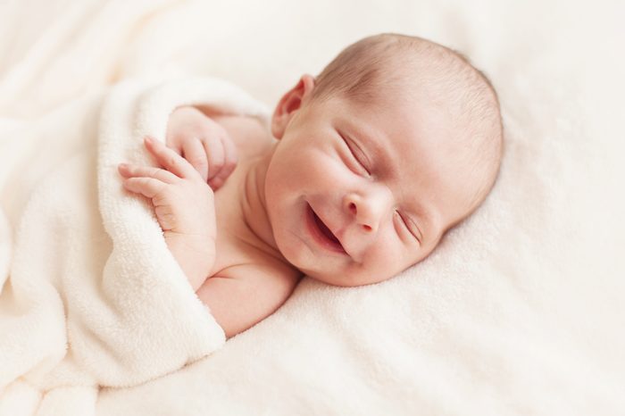 Smiling newborn baby 6 days old