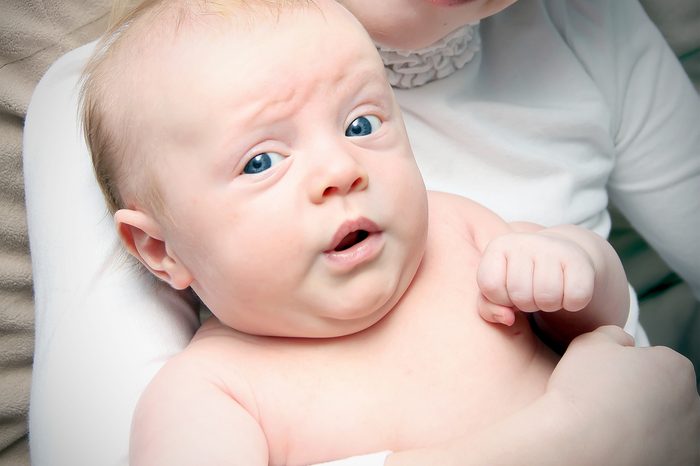 Adorable little girl with the bunny ears and basket of Easter eggs. 