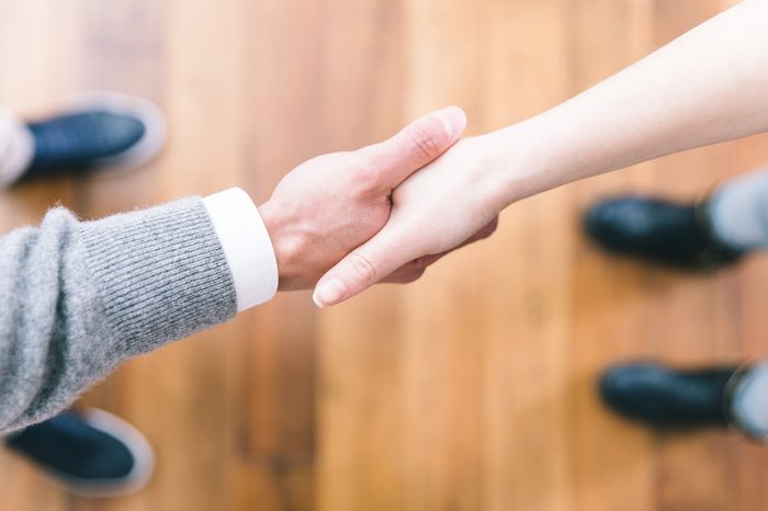 Business deal handshake from above. Straight focus on the hands